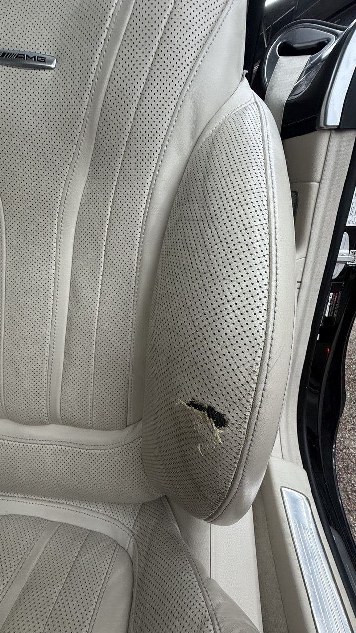 Cream perforated seat with a tear