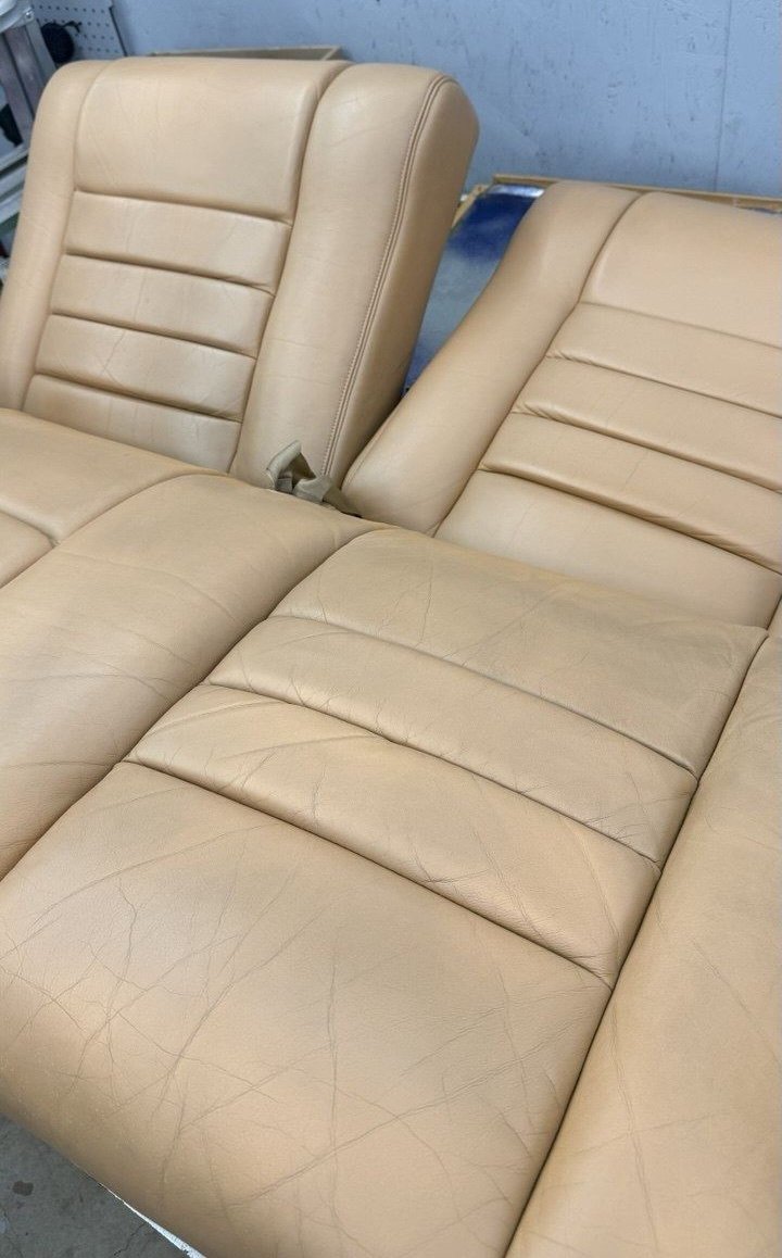 Tan rear bench, cracked and worn