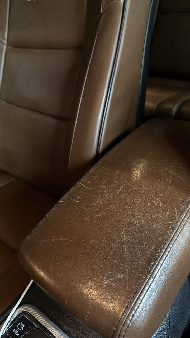 Brown console armrest, scratched