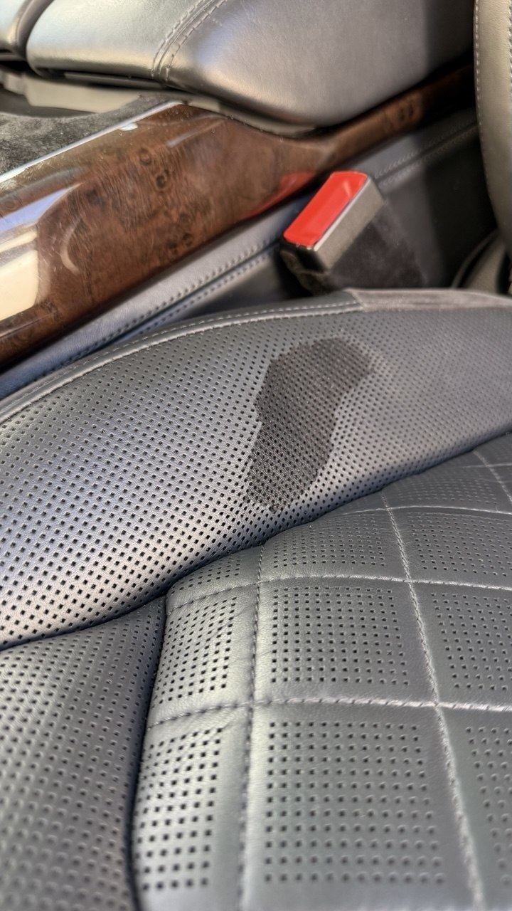 Grey perforated seat with a dark stain