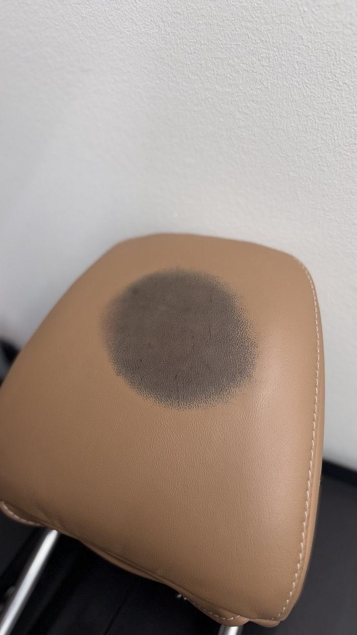 Tan headrest with a stain