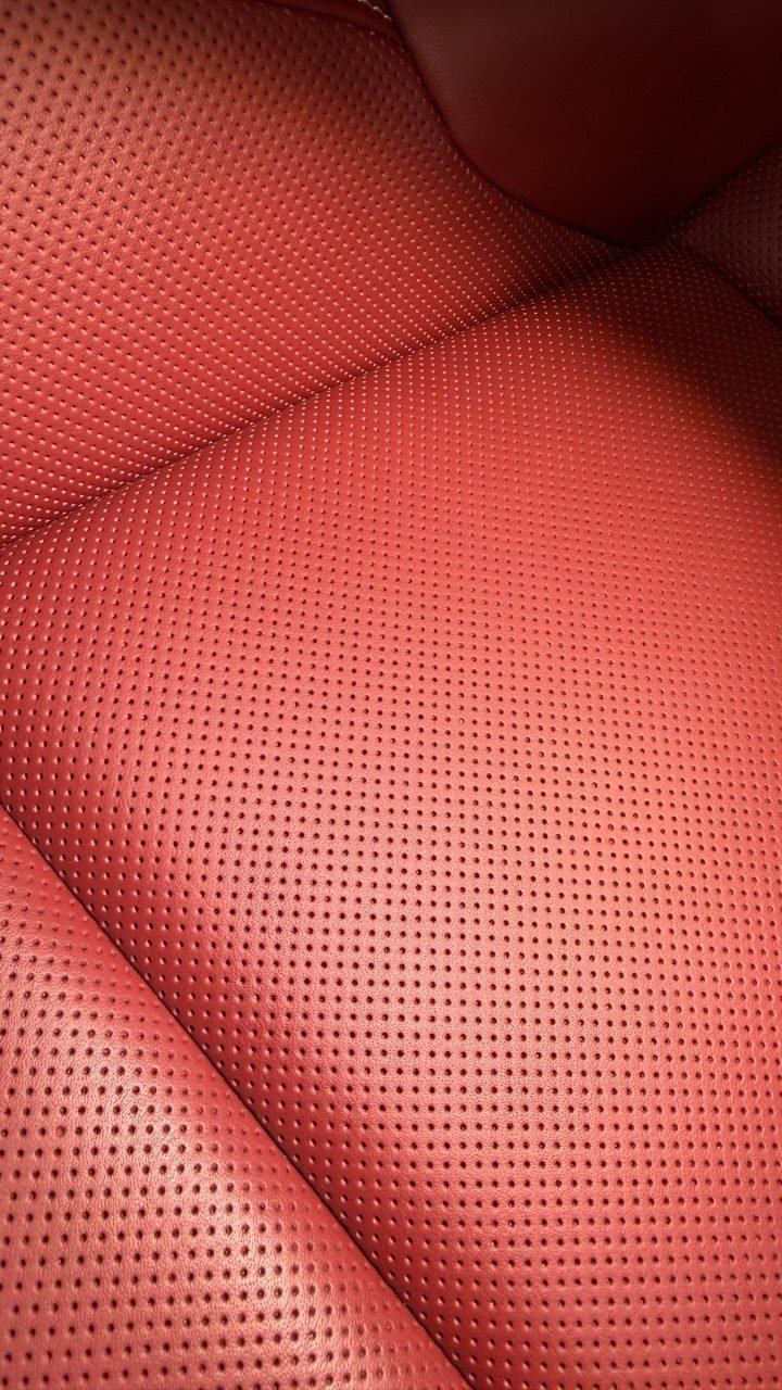 Perforated car seat, red leather, close grain