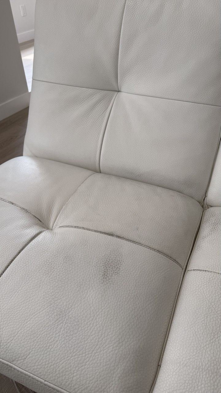 White leather sofa with greyed seat panels
