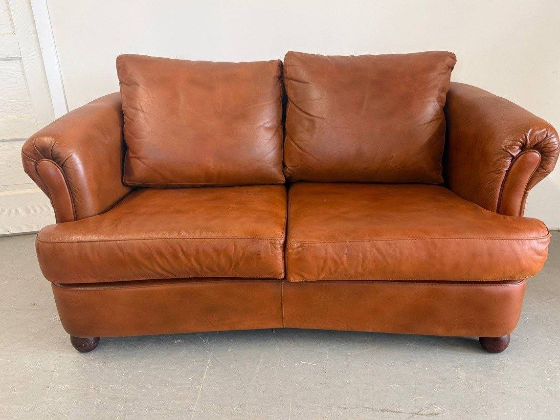 The same loveseat after restoration, cropped to match the before photo