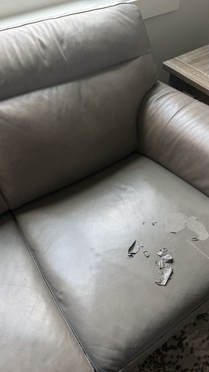 Grey leather armchair, finish lifting on the seat