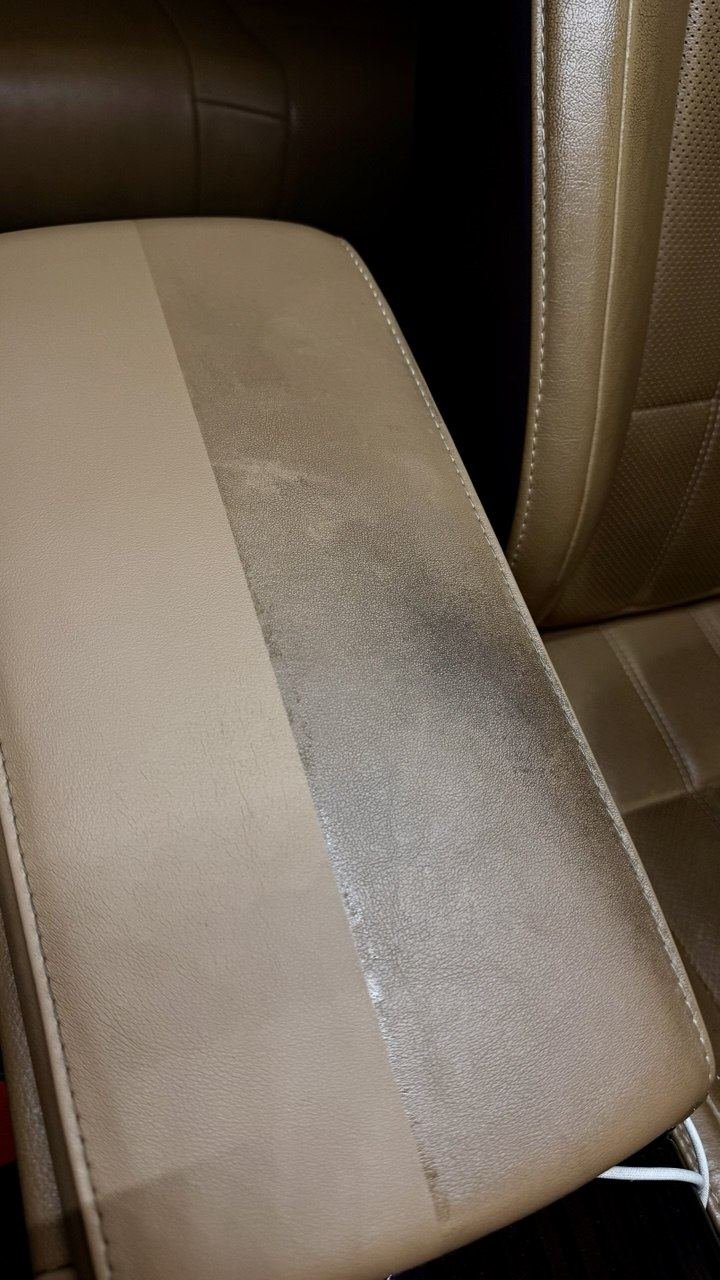 Car seat armrest, cleaned on one side of the tape line