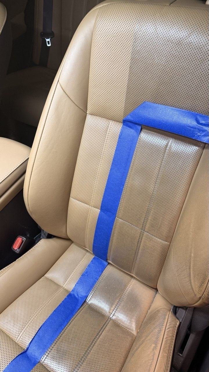 Tan car seat masked with tape, cleaned beside untouched leather