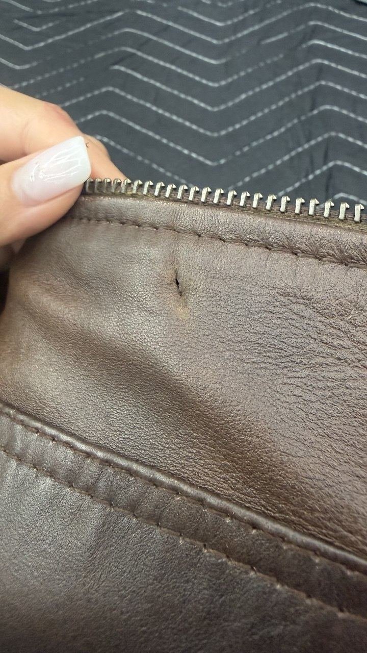 Brown leather jacket sleeve with a scratch across it