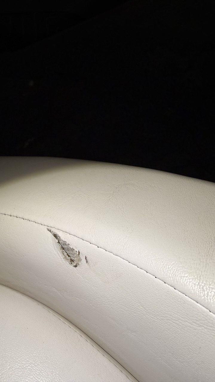 Torn white marine vinyl seat bolster