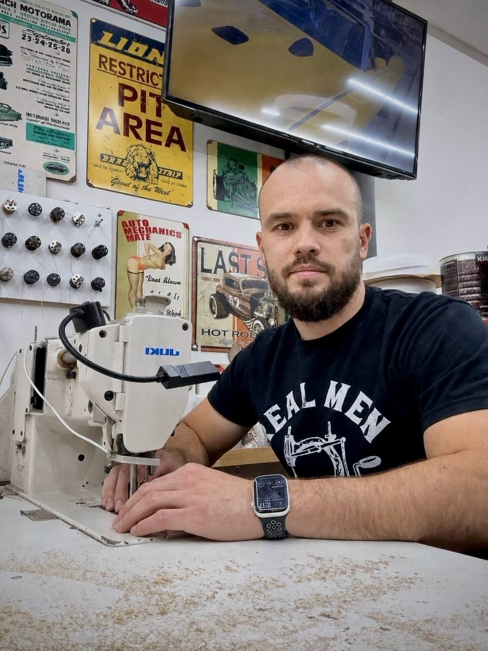 Pavel, in the workshop at his sewing machine