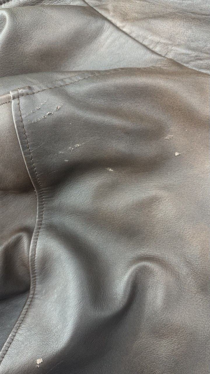 Black leather jacket with the finish peeling in spots