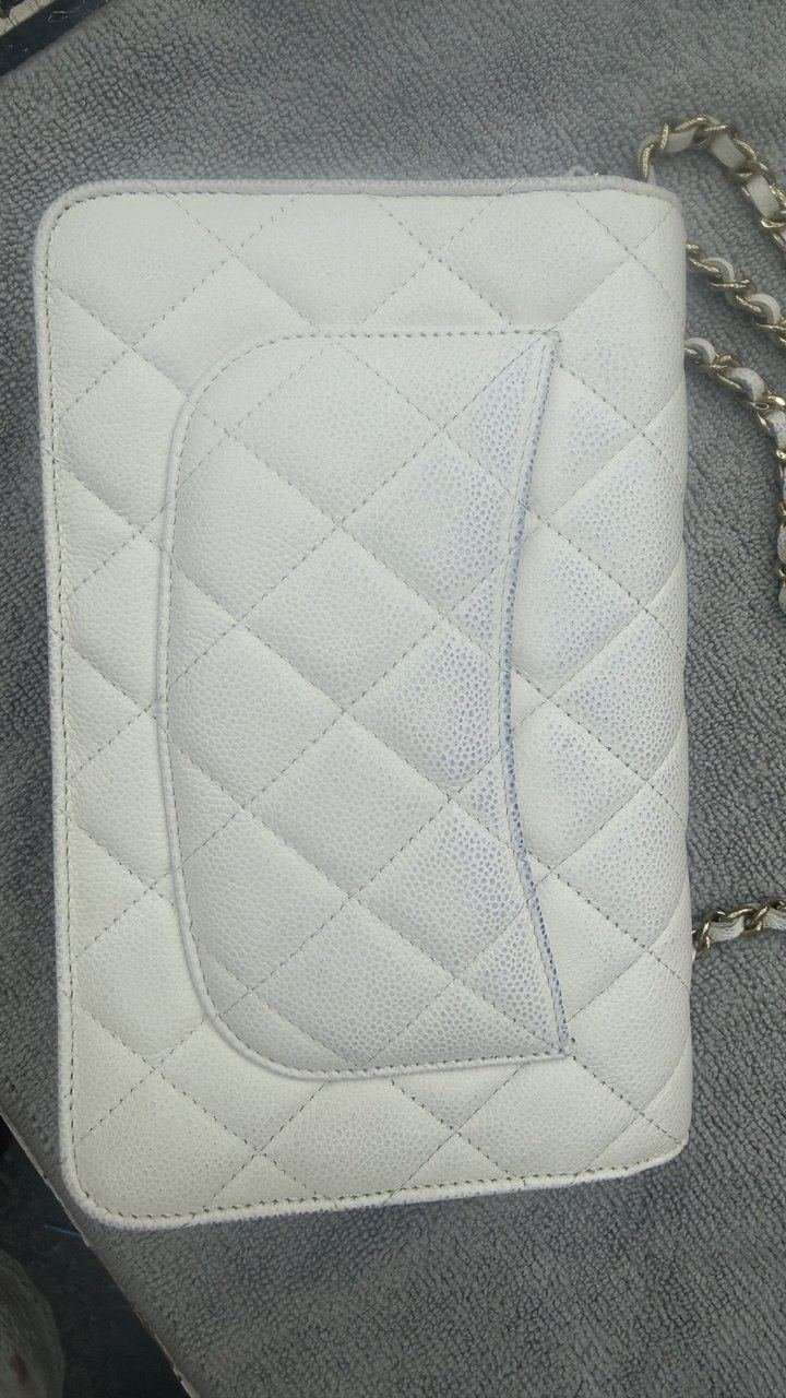Quilted flap bag with ink marks, before restoration