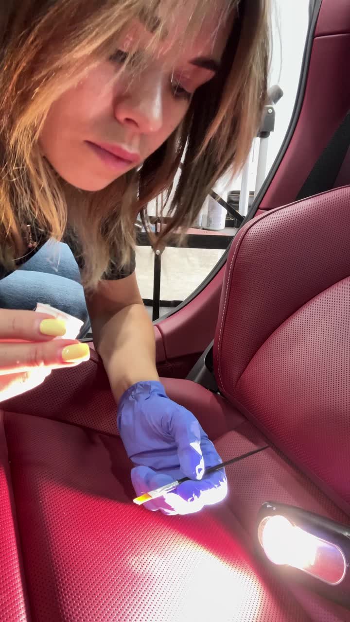 Valeri working on a red leather seat